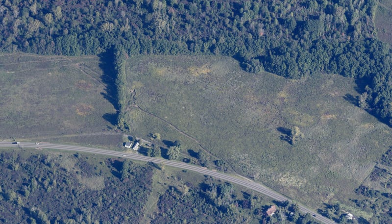 Aerial view of the proposed 5171 NY-31 development site in Clay, New York, showing open former farmland with State Route 31 frontage