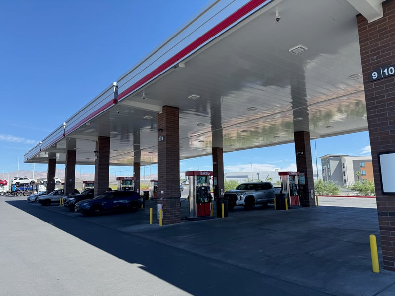 Quiktrip strategy: cost driver and the competitive weapon in one: doubling positions multiplies dispensers, piping runs and tank field size, pushing all-in cost toward the travel center band, and it is also how a site realistically clears the 3.5 to 4.0 million gallons a year a build of this class requires. The national average fueling site moves about 0.9 million. Concrete under the canopy instead of asphalt is a long-hold signal, higher upfront cost and better resistance to fuel degradation over a twenty-five year ownership.