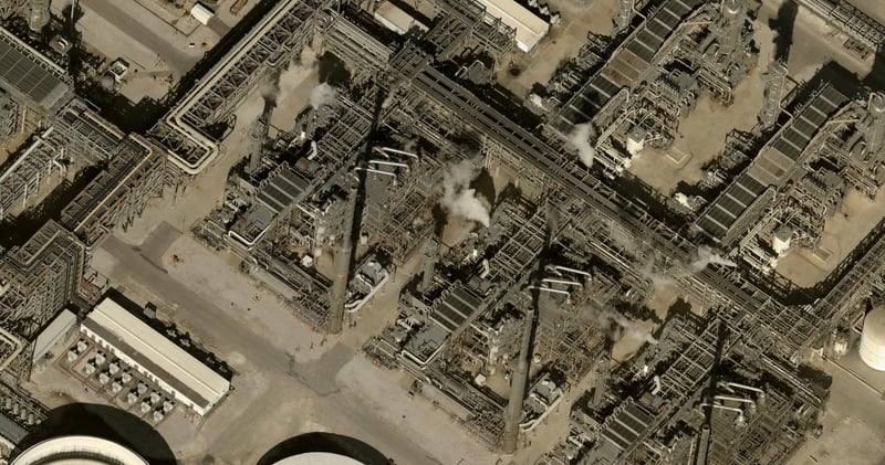 Close-up aerial of the refinery's distillation towers, catalytic cracking units, and associated heat exchange infrastructure during active operations, with visible steam emissions indicating real-time throughput across multiple processing trains. Satellite imagery captured by MMCG, January 4, 2026.
